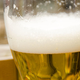 Close-up of beer glasses with white frothy bubbles on top